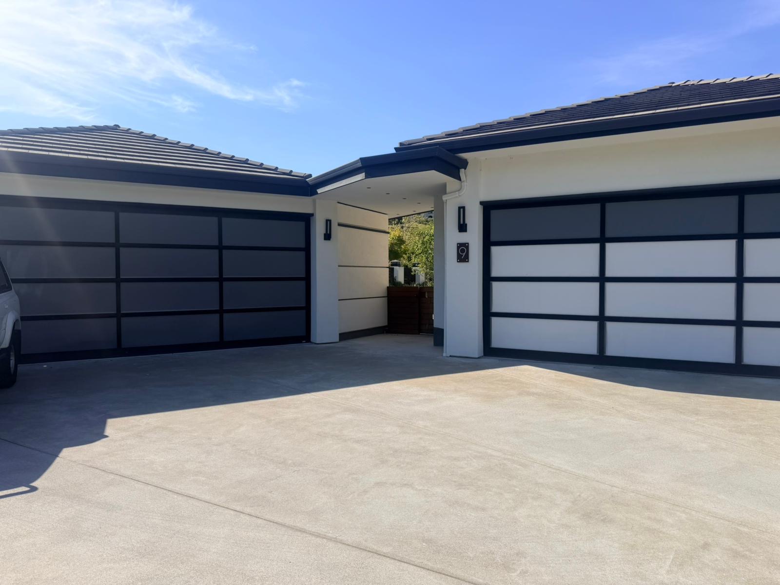 Dual black-frame full-view aluminum glass garage doors Bay Area installation