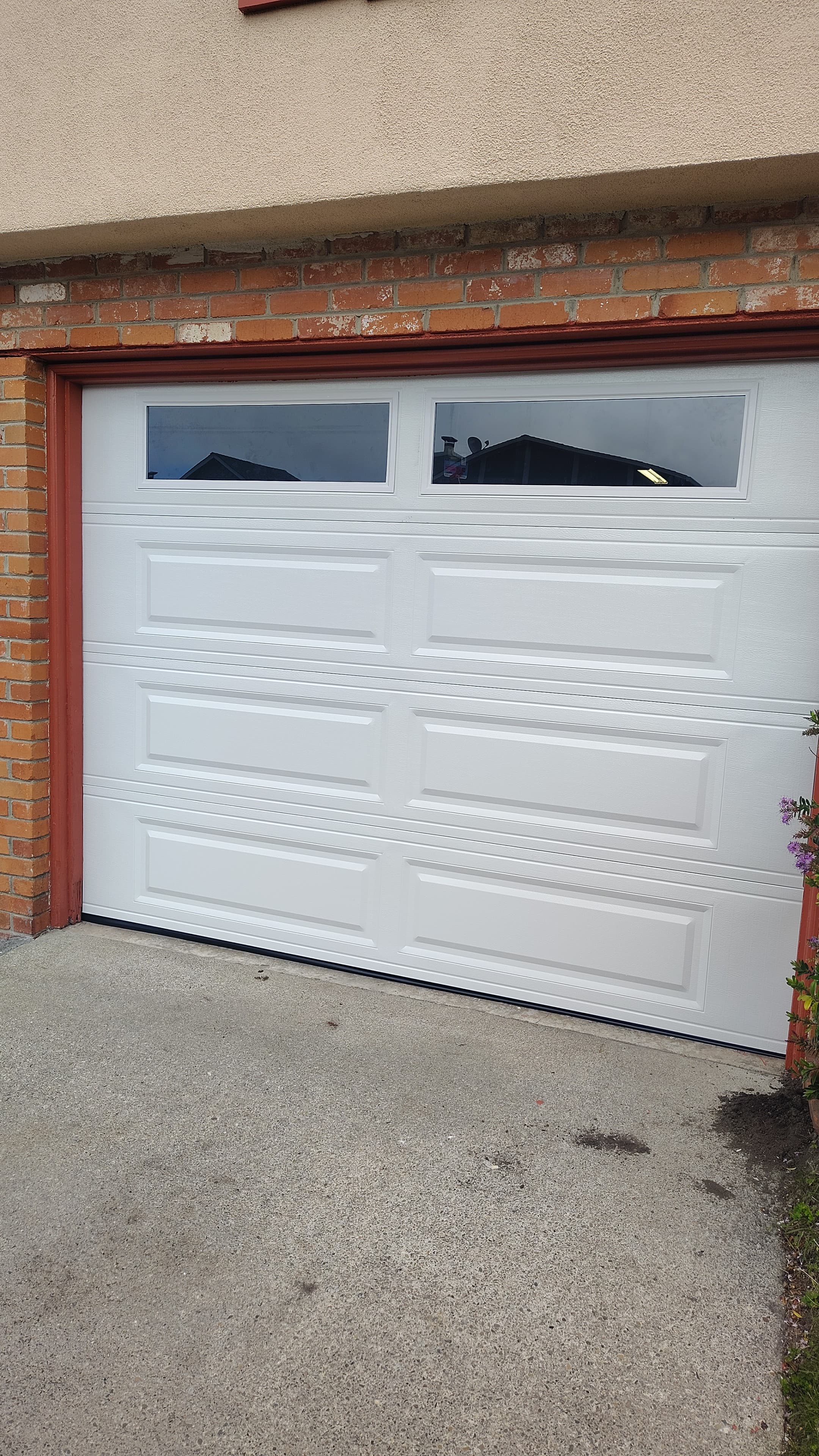 White raised panel garage door with transom windows installed Bay Area